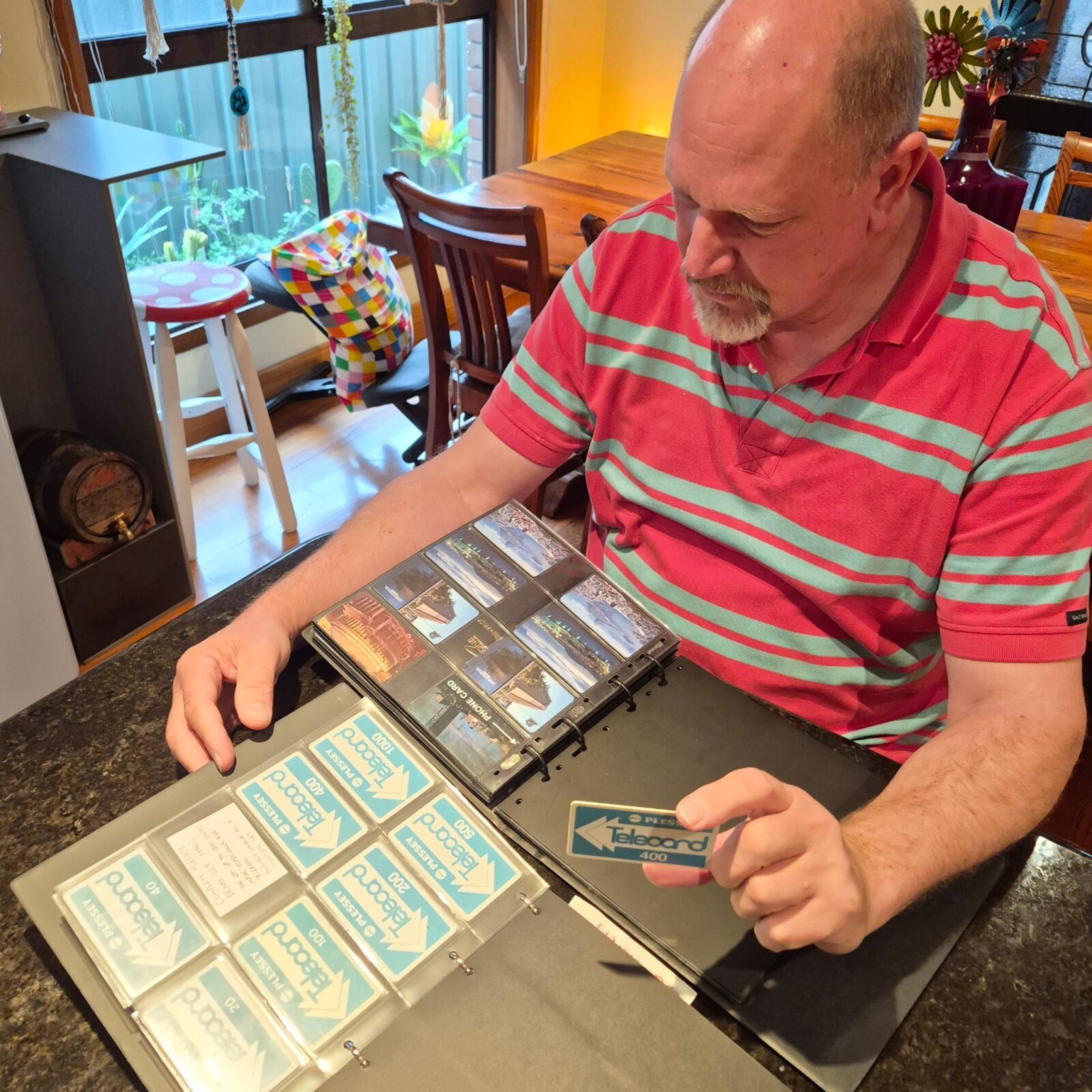 Eric Schuenemann, founder of the Phonecard Museum, examining rare Plessey Telecard trial cards, the expertise behind the Contribute to History project