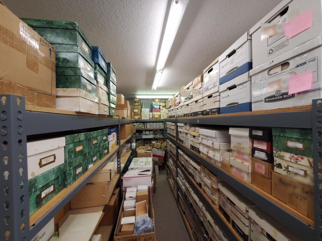 One of the storage rooms of Steve Schwartz's phonecard business in Florida, with labelled archive boxes on industrial shelving