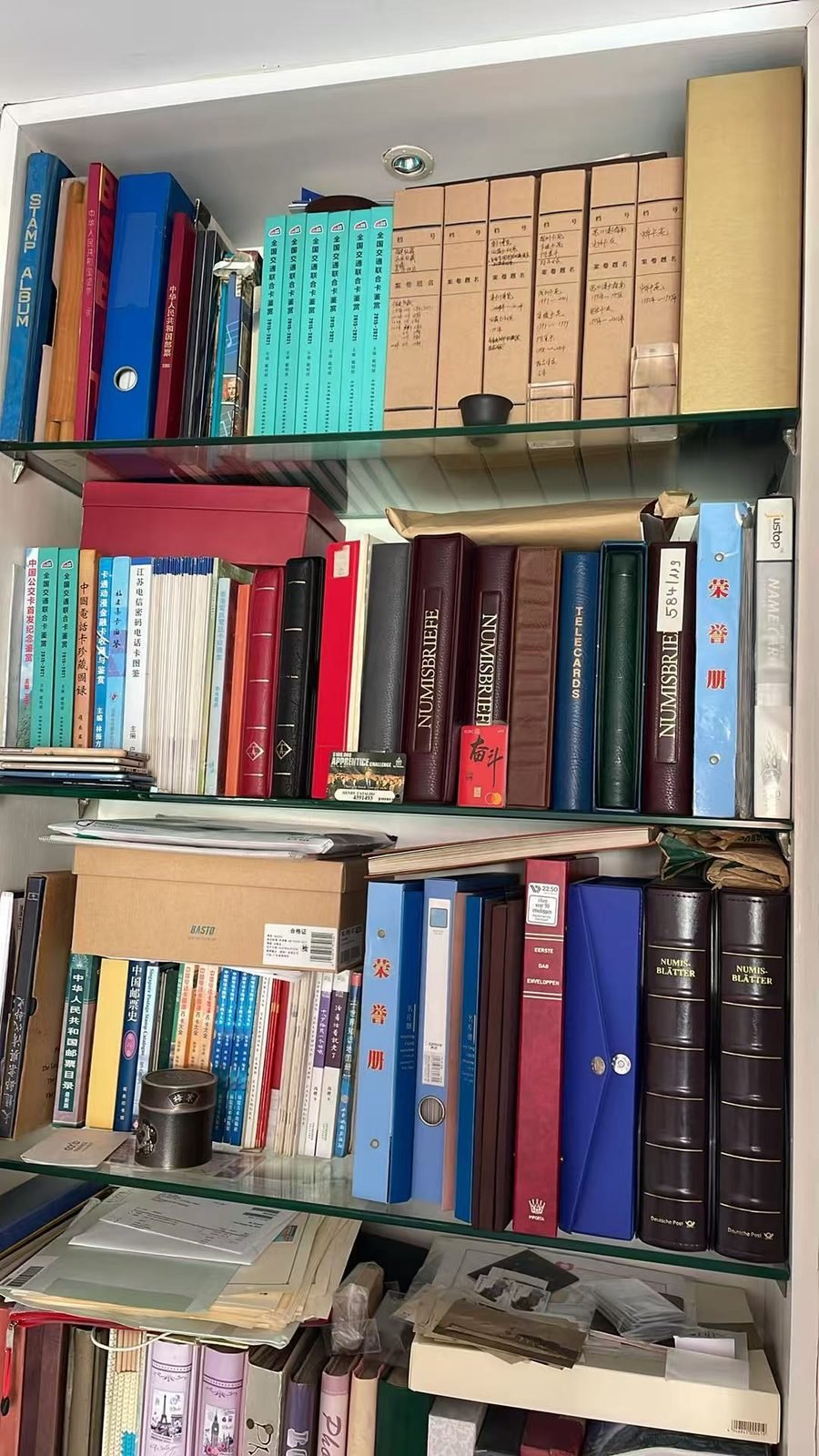 Shelves with phonecard albums and Chinese card catalogues in Yang Xiaodong's collection