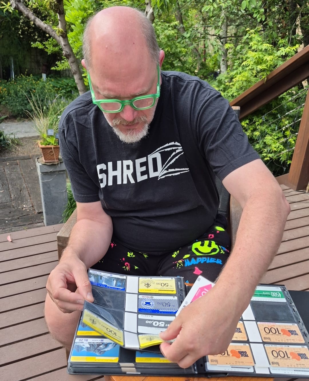 Eric Schuenemann carefully examining his Tamura and Anritsu phonecard collection in an open album