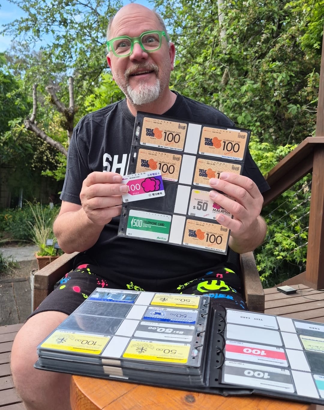 Eric Schuenemann, founder of the Phonecard Museum, holding a page of Anritsu SAMPLE phonecards from his Tamura and Anritsu collection